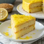 Wacky lemon cake slice with lemon zest close up