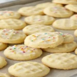 fresh-baked addicting mini sugar cookies on a wooden table