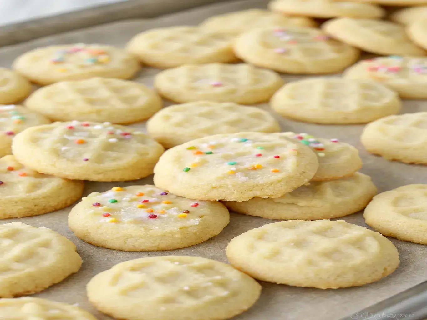 fresh-baked addicting mini sugar cookies on a wooden table